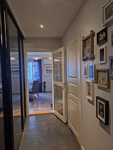 a hallway with a door leading to a living room at Hjemme koselig og sentralt leilighet in Fredrikstad