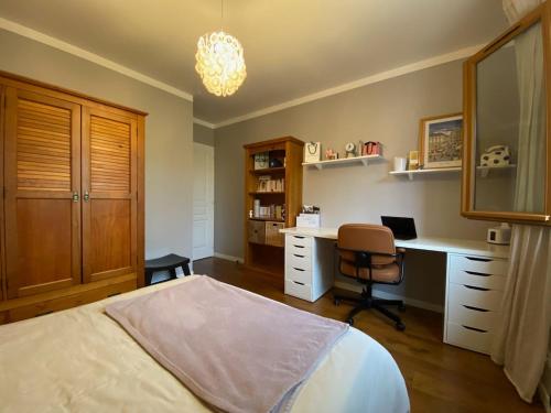 a bedroom with a bed and a desk and a chair at Sous les chênes de Lavaur - détente et télétravail in Lavaur