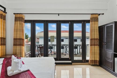 Postel nebo postele na pokoji v ubytování Central hotel Vang Vieng