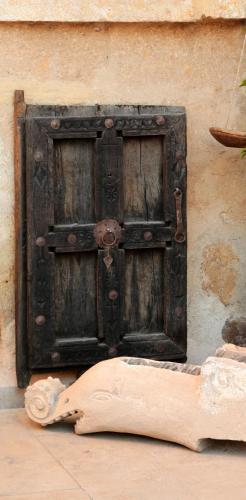 an old wooden door on the side of a building at Kirkit Hotel in Avanos