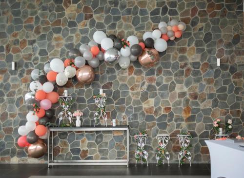 a bunch of balloons hanging on a wall at Loloata Island Resort in Loloata Island