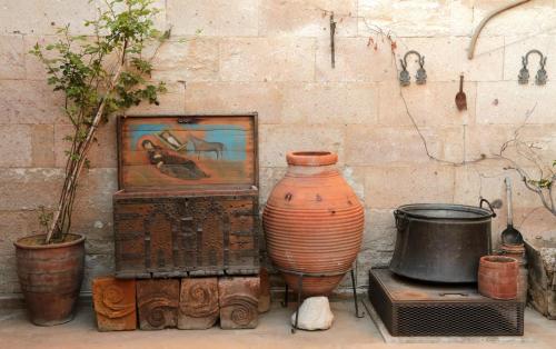 a vase sitting on a chest next to a painting at Kirkit Hotel in Avanos