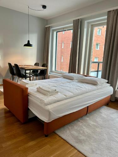 a bed in a bedroom with a table and a window at One bedroom apartment in Rovaniemi