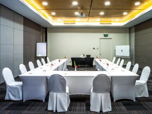 a conference room with a large white table and chairs at Loloata Island Resort in Loloata Island
