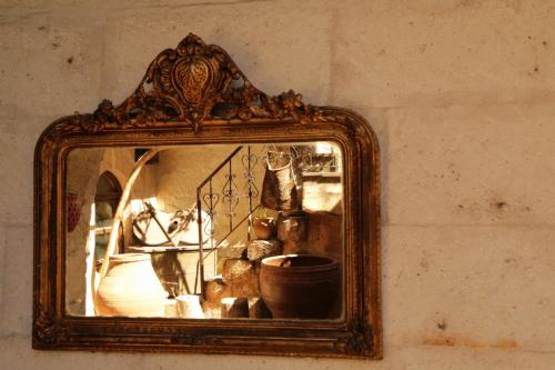 a mirror with a reflection of a room at Kirkit Hotel in Avanos