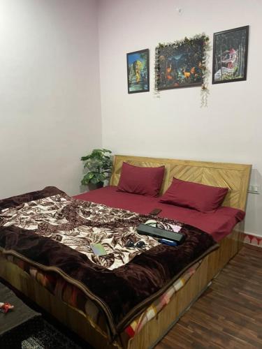 a bed with a laptop on top of it at the kasar devi stays in Almora