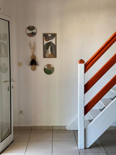 a staircase in a room with art on the wall at Tropical Mood city apartment 6 people in Grand-Bourg