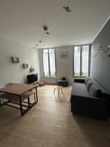 un salon avec un canapé et une table dans l'établissement Chez Noémie, à Saintes