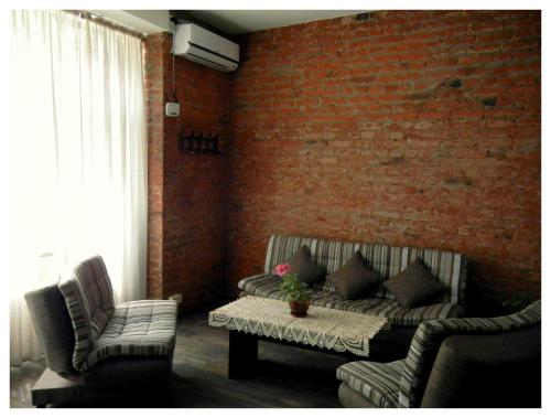 a living room with a couch and two chairs at Tbilisi Apartment in Tbilisi City