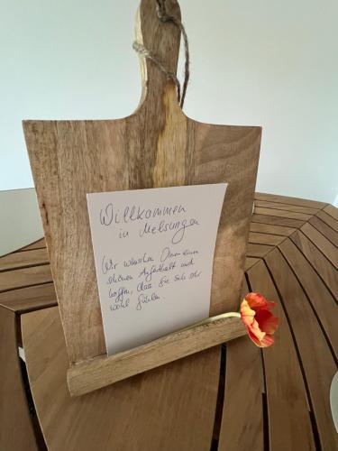 a sign on a chair with a flower on it at Fachwerk Rustikal in Melsungen