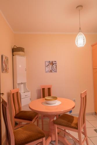 a dining room with a table and chairs at Apartmani Central 12 & Free parking in Vrnjačka Banja