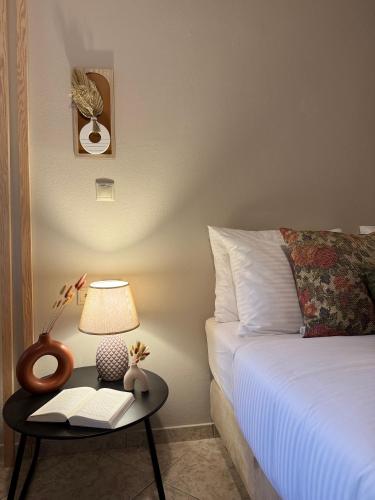 a bedroom with a bed and a table with a lamp at Casa Negiada in Agios Nikolaos