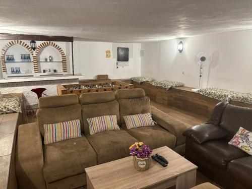 a living room with a couch and a table at Málaga casa grande familiar in Málaga