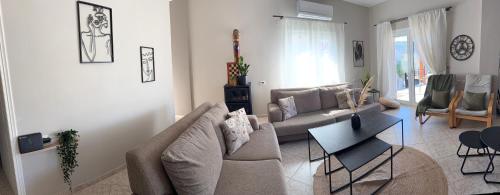 a living room with a couch and a table at Casa Negiada in Agios Nikolaos