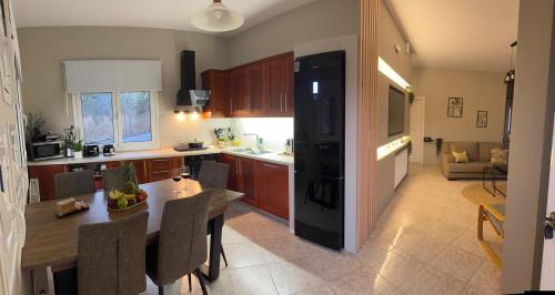 a kitchen with a table and a dining room at Casa Negiada in Agios Nikolaos