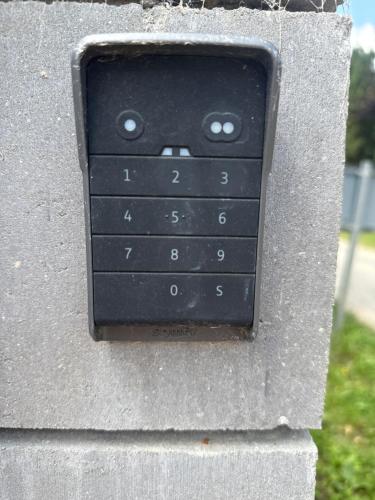 a black remote control attached to a wall at Maison en Colombage in Tilly