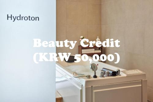 a sign that reads beauty credit kyrgyz crore in a bathroom at WE Hotel Jeju in Seogwipo