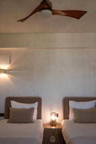 two beds sitting next to each other in a room at Hotel Galfi - Boutique & Adults Only in San Antonio
