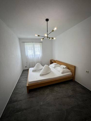 a bedroom with a bed and a chandelier at Apartment Oberleins III in Arzl im Pitztal