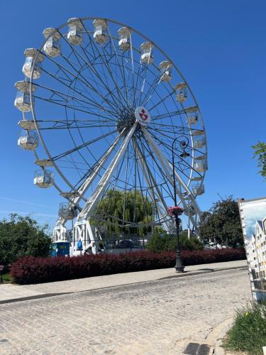 a large ferris wheel in a park at Apartament Bulvar Starówka in Elblag