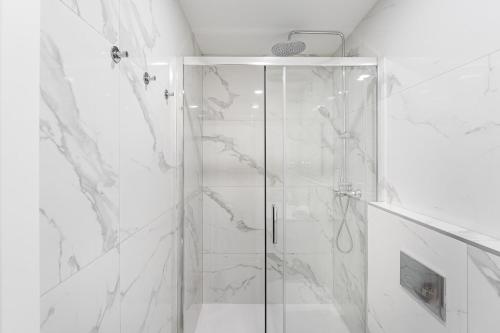 a shower with a glass door in a bathroom at Terraced Apartment in the Heart of Porto - Free Parking in Porto