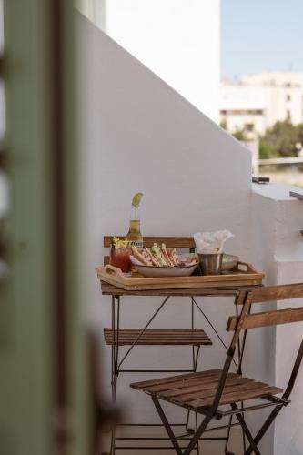 a table with a plate of food on it with two chairs at Hotel Galfi - Boutique & Adults Only in San Antonio