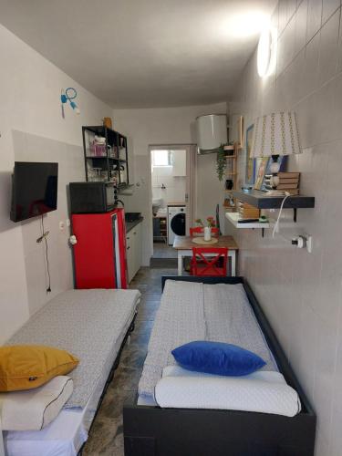 a small room with two beds and a kitchen at Studio Booksa in Premantura