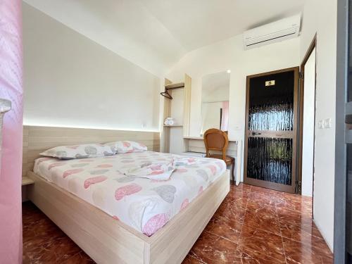 a bedroom with a bed and a chair in it at Villa Kasa in Durrës