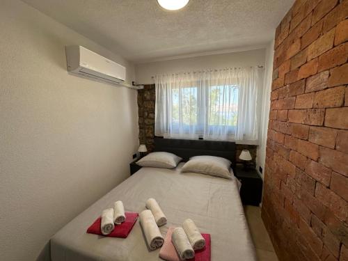 a bedroom with two beds with towels on them at Beachfront Villa Amfora with Pool in Karlobag