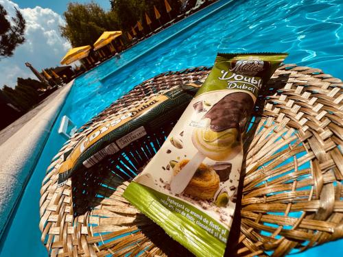 a basket with a bag of food on top of a pool at Hanul Lui Bogdan Economy INN in Făget