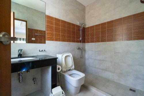 a bathroom with a toilet and a sink at Baan Faa Talaychan Resort in Chao Lao Beach