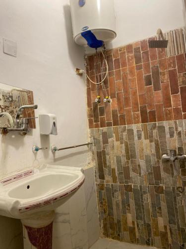 a bathroom with a sink and a shower at sphinx one centre hotel in Banī Ghālib