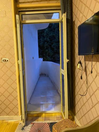 a door that is open in a room with a floor at sphinx one centre hotel in Banī Ghālib