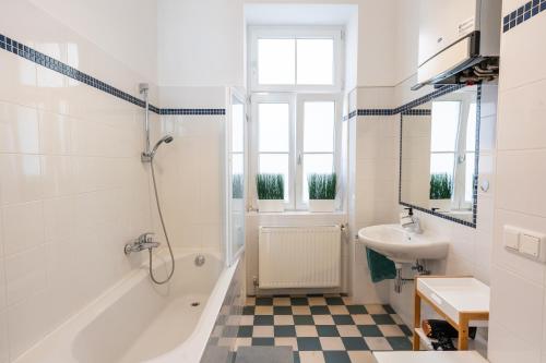 a bathroom with a tub and a sink and a shower at Premium Suites Vienna - City Stay in Vienna