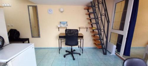 a kitchen with a desk and a chair in a room at Apartment in a house among three beaches in Sutomore