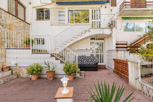 an outdoor patio with a staircase and plants at Casa Mihales in Tarragona