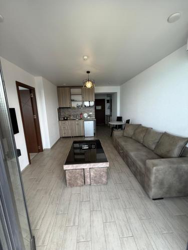 a living room with a couch and a table at Batum World 2014 in Batumi