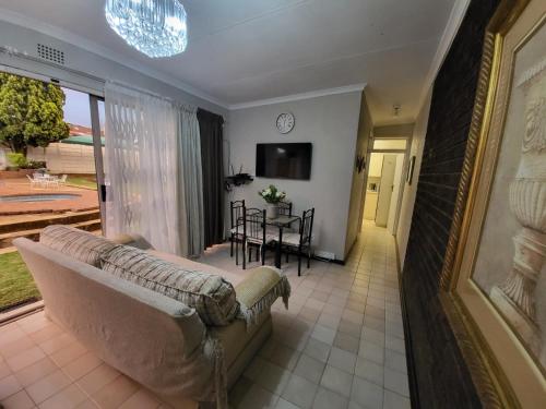 a living room with a couch and a table at Villa Francisco Bed & Breakfast Solar Power in Germiston