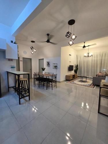 a large living room with a table and chairs at Homestay D'Casa, Apartment In Sepang, KLIA in Sepang