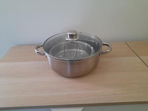 a metal pot sitting on top of a wooden table at Authenticity Preserved in Brionne