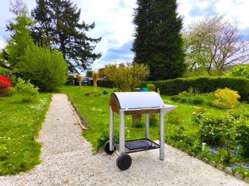 a white stove on wheels in a garden at Authenticity Preserved in Brionne