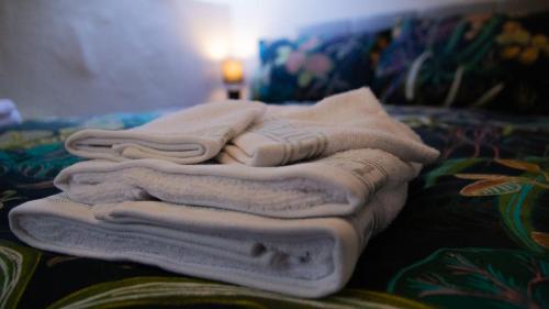 a pile of towels sitting on top of a couch at The Gallery Cottage in Castledawson