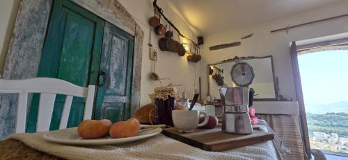 a table with a plate of fruit and a coffee maker at The Cedro part of The Orangery Luxury Retreat in Tursi