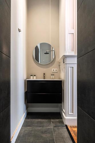 a bathroom with a sink and a mirror at City center located City Villa Tilburg Alexander in Tilburg