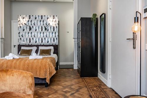 a bedroom with a bed and a couch in it at City center located City Villa Tilburg Alexander in Tilburg