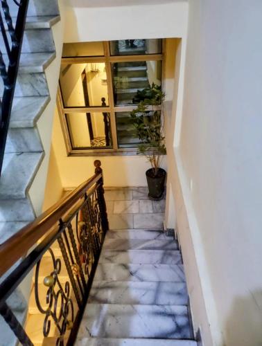 a staircase with a mirror and a potted plant at Keba Guest INN in Addis Ababa