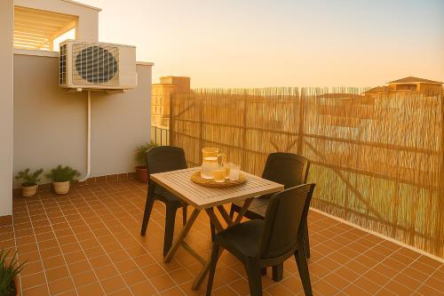 a table and chairs on a balcony with a heater at La Dimora degli Artisti in Pescara