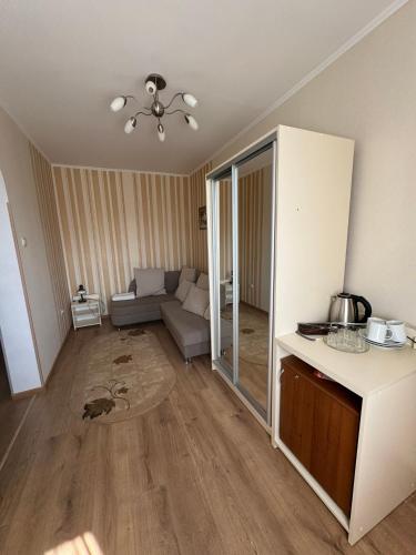 a living room with a couch and a table at Сонячна Перлина in Polyana