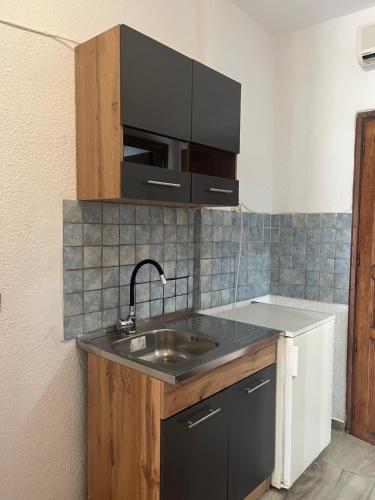 a kitchen with a sink and a microwave at Hotel Paradise Ouranoupolis in Ouranoupoli