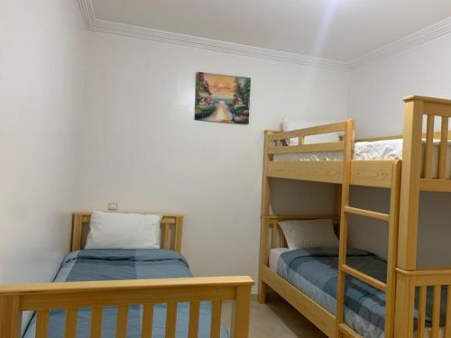 a bedroom with two bunk beds and a bed at Tanger Relax Appartement in Tangier